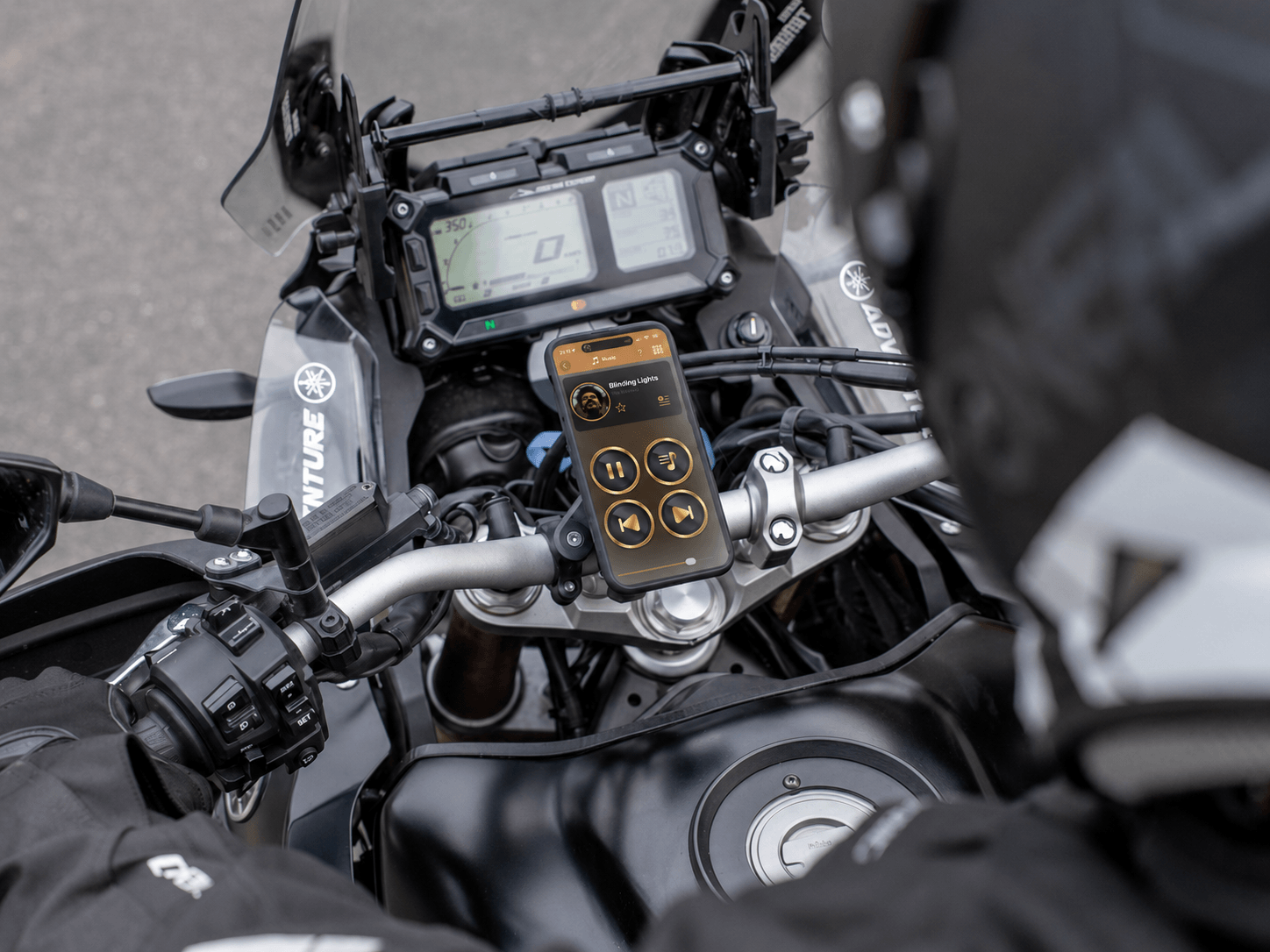 An iPhone mounted above a motorcycle's handlebars for navigation
